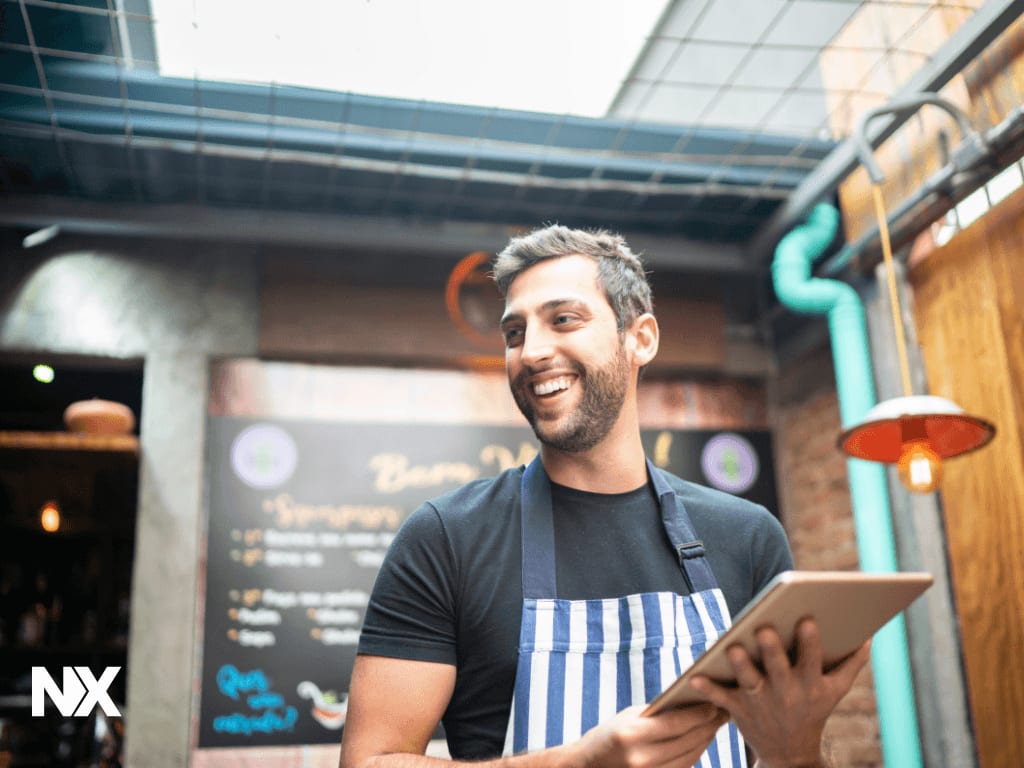 Restaurant manager reviewing a shift report on a tablet