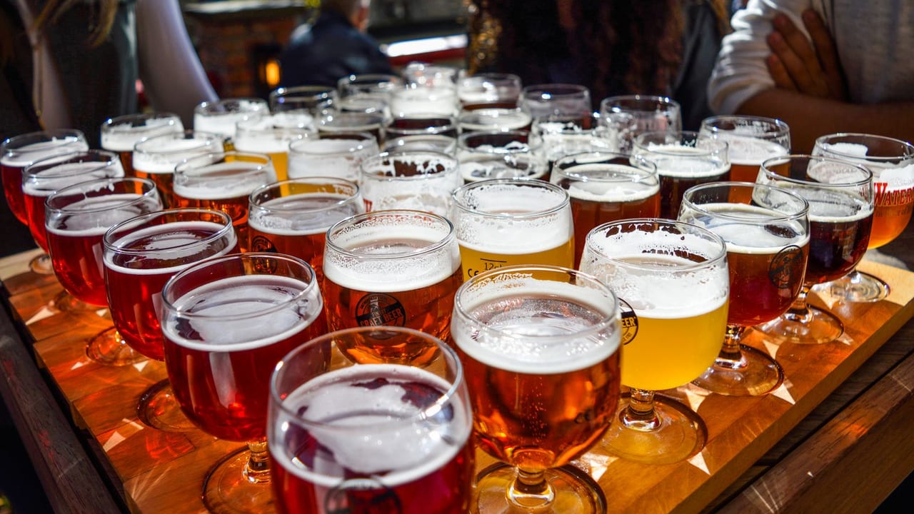 Group at an outdoor table choosing beers together.