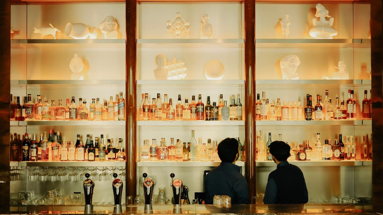 Hotel lobby bar with staff working behind the counter.
