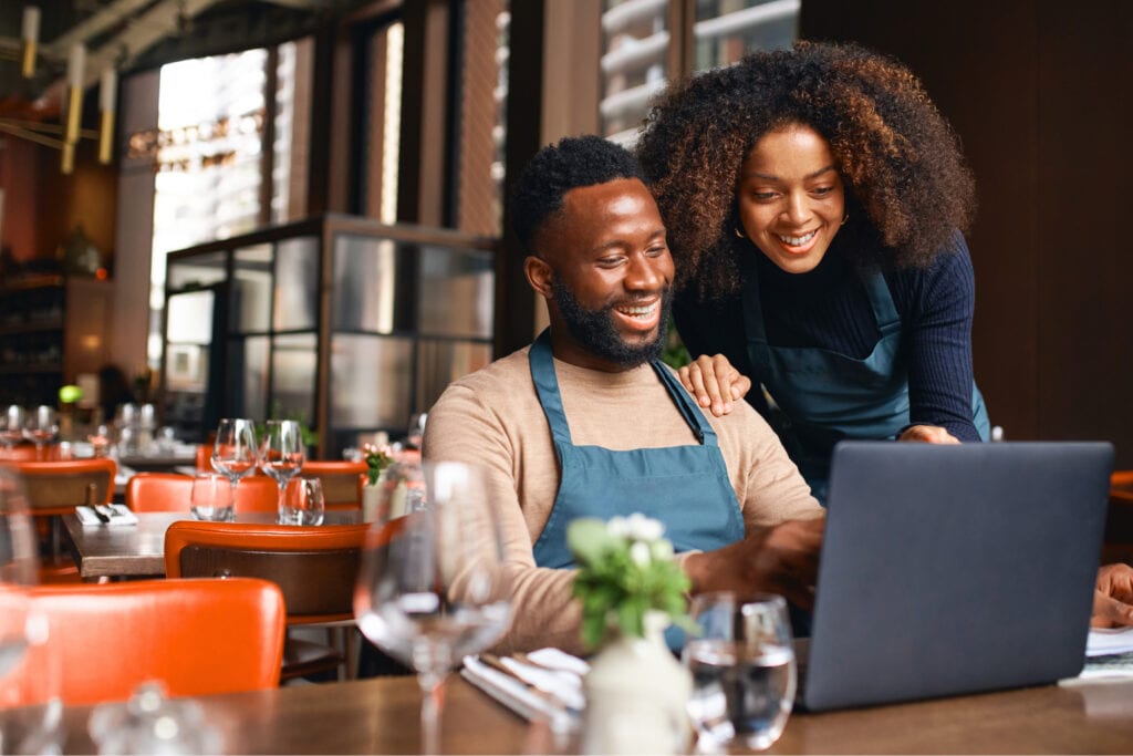 A restaurant manager using NX Restaurant from their laptop