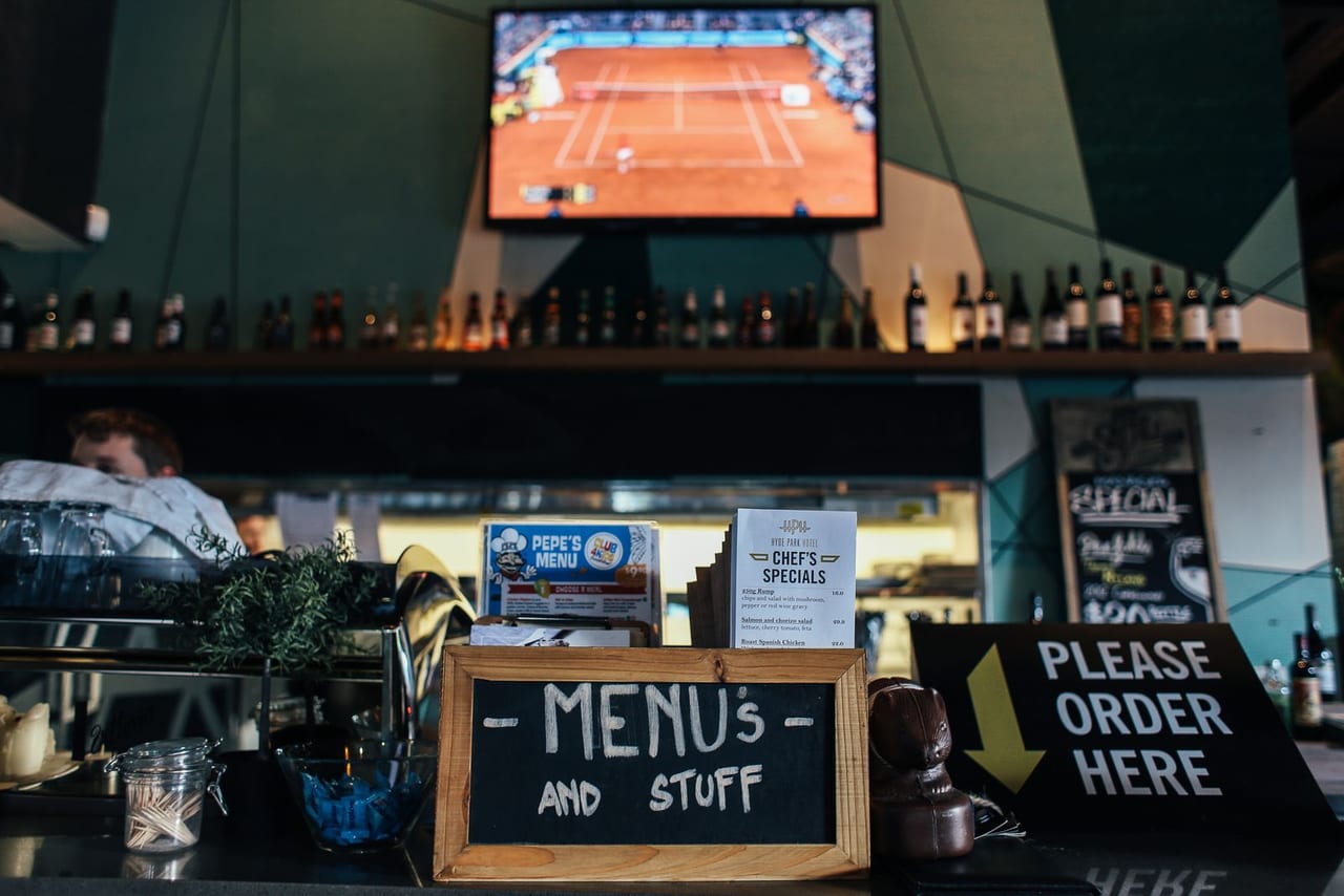 Bar counter during service with drinks lined up.