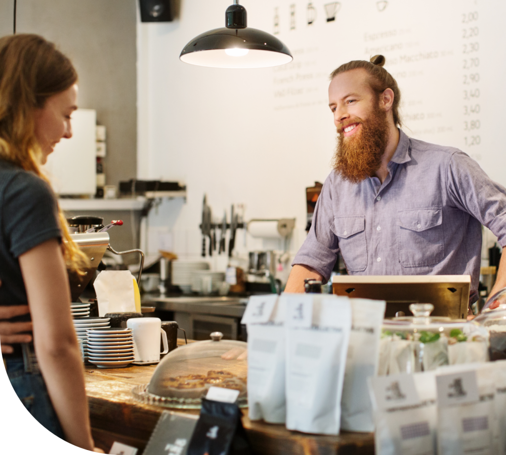 man helping customer out on register